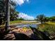 Serene golf course view with water feature at 3444 Mistletoe Ln, Longboat Key, FL 34228