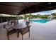 Covered patio area overlooking the pool at 3444 Mistletoe Ln, Longboat Key, FL 34228