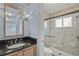 Bathroom with single vanity, shower, and black granite countertop at 3614 E 62Nd Ave, Bradenton, FL 34203