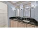 Bathroom with double vanity and black granite countertop at 3614 E 62Nd Ave, Bradenton, FL 34203