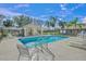 Inviting community pool with ample lounge chairs under the Florida sun at 3614 E 62Nd Ave, Bradenton, FL 34203