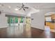 Bright living room featuring sliding doors to a patio, hardwood floors, and a kitchen at 3614 E 62Nd Ave, Bradenton, FL 34203