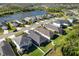 Aerial view of a residential neighborhood with houses, streets and a lake at 3632 Shimmering Oaks Dr, Parrish, FL 34219