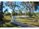 Large fenced backyard with mature trees and lush grass at 3632 Shimmering Oaks Dr, Parrish, FL 34219