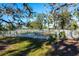 Fenced grassy backyard with a picnic table under shade trees at 3632 Shimmering Oaks Dr, Parrish, FL 34219