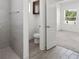 Bathroom with shower, toilet and grey tile floor at 3632 Shimmering Oaks Dr, Parrish, FL 34219