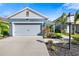 Two-story home with a gray roof and blue siding, two-car garage, and landscaping at 3632 Shimmering Oaks Dr, Parrish, FL 34219