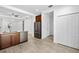 Open kitchen with island, stainless steel appliances, and access to hallway at 3632 Shimmering Oaks Dr, Parrish, FL 34219