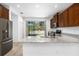 Kitchen island with granite countertop, stainless steel appliances, and view to backyard at 3632 Shimmering Oaks Dr, Parrish, FL 34219