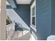 Small side porch with white railing and blue exterior at 3632 Shimmering Oaks Dr, Parrish, FL 34219