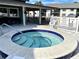 Community hot tub with surrounding patio furniture and grilling area at 4320 47Th W Ave # 203, Bradenton, FL 34210