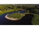 Aerial view of a single golf green surrounded by water at 4501 Murcia Blvd # 7, Sarasota, FL 34238