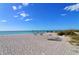 Relaxing beach view with chairs and umbrellas at 4545 Gulf Of Mexico Dr # 408, Longboat Key, FL 34228