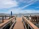 Private waterfront dock with seating area at 520 Bayport Way, Longboat Key, FL 34228