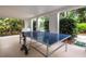 Outdoor ping pong table under covered patio at 520 Bayport Way, Longboat Key, FL 34228