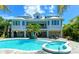 Inviting pool and spa with lounge chairs and surrounding patio at 520 Kumquat Dr, Anna Maria, FL 34216