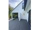 Backyard deck with white stucco walls and tropical plants at 5373 Dominica Cir, Sarasota, FL 34233