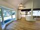 Sunlit dining area with large bay window and stylish chandelier at 5373 Dominica Cir, Sarasota, FL 34233