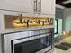 Stainless steel microwave with decorative light above at 5373 Dominica Cir, Sarasota, FL 34233