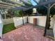 Brick patio with pergola, landscaping, and water feature at 5373 Dominica Cir, Sarasota, FL 34233