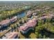 Aerial view of community near a lake, showcasing buildings and landscape at 5601 Bentgrass Dr # 10-117, Sarasota, FL 34235