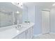 Elegant bathroom with white quartz countertop, subway tile shower, and a large mirror at 5601 Bentgrass Dr # 10-117, Sarasota, FL 34235