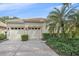 Two-car garage with a brick paved driveway and neatly trimmed hedges at 6219 Skyward Ct, Bradenton, FL 34203