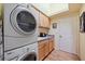 Laundry room with washer, dryer, and ample cabinet storage at 6219 Skyward Ct, Bradenton, FL 34203