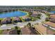 Community overview featuring lake, lush landscaping and homes at 6517 Willowshire Way, Bradenton, FL 34212