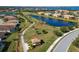 Community view, showcasing homes, lake, and walking path at 6517 Willowshire Way, Bradenton, FL 34212