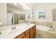 Bathroom with double vanity and garden tub at 6517 Willowshire Way, Bradenton, FL 34212