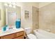 Bathroom showing tiled shower/tub combo, single vanity, and framed decor at 6517 Willowshire Way, Bradenton, FL 34212