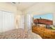 Bedroom showcasing a television, wooden dresser, and access to other rooms at 6517 Willowshire Way, Bradenton, FL 34212