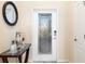 Beautiful front door with glass insert and stylish foyer decor at 6517 Willowshire Way, Bradenton, FL 34212