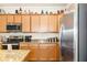 Kitchen featuring wooden cabinets, granite countertops and modern appliances at 6517 Willowshire Way, Bradenton, FL 34212