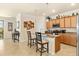 Bright kitchen featuring a granite-topped island with seating, and ample wooden cabinetry at 6517 Willowshire Way, Bradenton, FL 34212