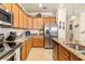 Kitchen with granite countertops, stainless steel appliances and light wood cabinets at 6517 Willowshire Way, Bradenton, FL 34212