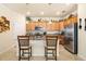 Kitchen with light wood cabinets, granite countertops, and stainless steel appliances at 6517 Willowshire Way, Bradenton, FL 34212