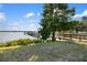 Wooden pier by the lake with a large tree nearby at 6517 Willowshire Way, Bradenton, FL 34212