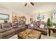 Open-concept living room with modern sofas and a seamless flow into the kitchen and dining area at 6517 Willowshire Way, Bradenton, FL 34212