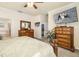 Main bedroom with decorative wood furniture, large television, and access to the bathroom at 6517 Willowshire Way, Bradenton, FL 34212