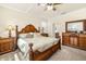 Main bedroom with ensuite bathroom access and wooden furniture at 6517 Willowshire Way, Bradenton, FL 34212