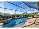 Screened-in pool and spa overlook lush landscaping and a peaceful lake at 6517 Willowshire Way, Bradenton, FL 34212