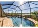 Screened-in pool with a spa and lake view at 6517 Willowshire Way, Bradenton, FL 34212