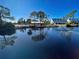 Scenic view of a tranquil pond with community buildings at 6800 Placida Rd # 2016, Englewood, FL 34224