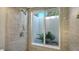 Shower with tile surround and window providing natural light at 754 N Jefferson Ave # 754, Sarasota, FL 34237