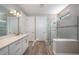 Modern bathroom with a large shower, double vanity, and white cabinets at 7845 Mainsail Ln, Sarasota, FL 34240