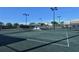 Well-maintained tennis court with seating area at 8755 Olde Hickory Ave # 7101, Sarasota, FL 34238