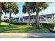 Building exterior with lush landscaping and palm trees at 905 Addington Ct # 102, Venice, FL 34293