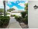 Landscaped walkway leading to the building entrance at 905 Addington Ct # 102, Venice, FL 34293